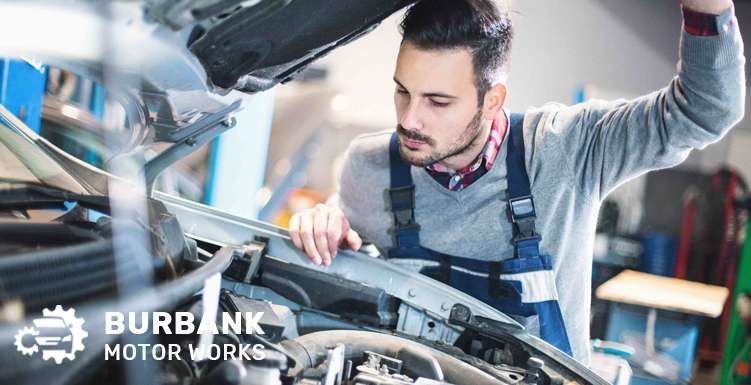 Mechanic inspecting a timing belt for wear and damage.