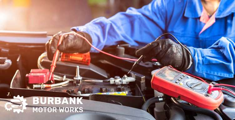 Mechanic Testing a Car Battery for Performance